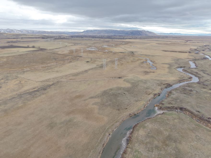 Rare opportunity to purchase a large 442.49 acre cattle ranch in Bear Lake with irrigated crop ground, meadow, and summer range ground! In addition to a small, older ranch house and several outbuildings. Lots of frontage on Bench Rd, too, if looking to develop a couple building lots for your family or to resell and make back some of your investment quickly! Great ag ground with good water, including 79 shares from Preston Montpelier Irrigation Co, and even has Bear River running along Western border. 5 total parcels included. 282.49 acres along Bench Rd with house, comprised of irrigated crop ground and meadow, and separate 160 acres of slightly higher range ground about 3 miles East. Sellers also have 94 head of cattle and a National Forest grazing permit that can be included for additional cost. Existing land lease with third party must be honored by buyers even after closing. Great operation ready for you to have or expand your Bear Lake cattle ranch! Call today!