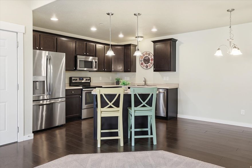 Experience effortless main-level living in this stunning 3-bedroom, 2-bathroom Centerville condo. The open floor plan features a chef-inspired kitchen with upgraded cabinetry and LVP flooring, while the spacious primary suite serves as a private retreat with its own ensuite bathroom.  Sunlight fills the living area, which opens to a shaded patio and storage. Beautiful mountain view and meticulously maintained with a 2023 water heater and 2026 professional updates, this home is move-in ready. Enjoy Pineae Village amenities like the pool and pavilion, plus HOA-covered exterior maintenance, sewer, water, and trash. This home also includes lawn care, snow removal, and a designated carport. Located near top-rated Davis schools and Centerville Plaza with easy access to I-15.    Square footage figures are provided as a courtesy estimate only and were obtained from tax data. Buyer is advised to obtain an independent measurement.