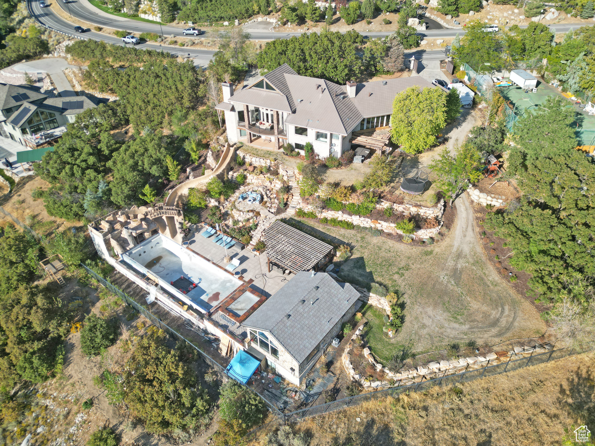 ALL OFFERS TO BE SUBMITTED BY 5:00PM ON FRIDAY, October 10th. THE SELLERS WILL RESPOND BY 5:00PM TUESDAY, October 14TH. Paradise found! Just needs a little work. This magnificent 7,000 sq. ft. estate sits on one of the most exquisite view lots at the base of Little Cottonwood Canyon. Over $1 Million have been spent on the spectacular back yard with a 66ft. x 22ft. wide infinity edge swimming pool. There's the longest water slide that leads from the top terrace home level that takes you right into the pool as it meanders through the beautifully landscaped yard. There's a guest house with slate tile roof and outdoor showers. The 2 all glass sliding doors opens up to create an indoor outdoor atmosphere adjacent to the most gourmet of all outdoor kitchens complete with a restaurant style pizza oven. Too much to list, so just call us for a private tour. 24 hr Notice to Show.