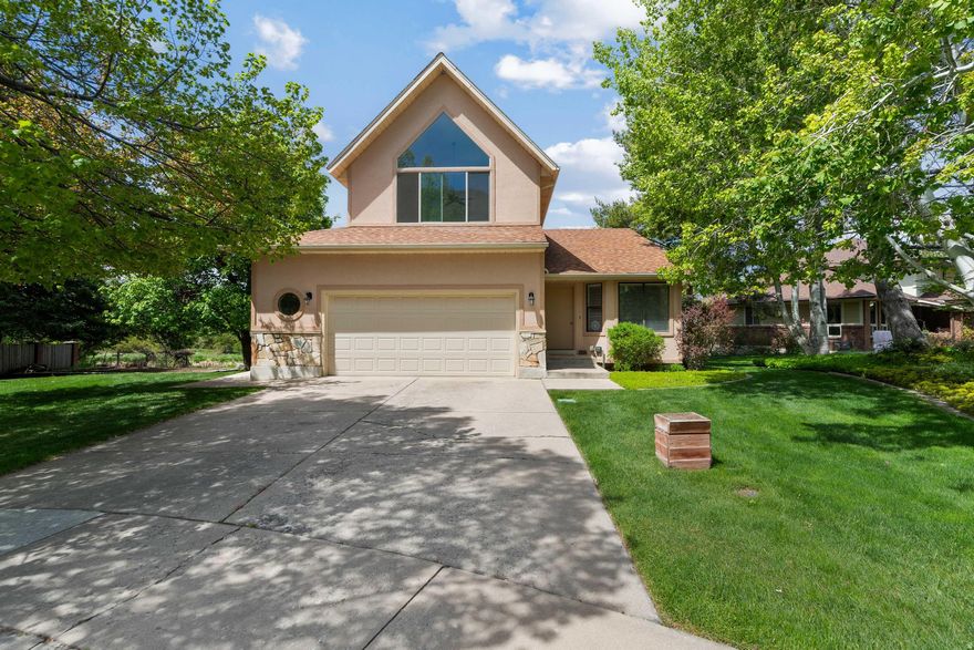 This well-built, custom home features a spacious, open floor plan with vaulted ceilings on the main level and in the master suite. The kitchen offers a breakfast nook with views of the yard, garden plot, canal with resident ducks, and beautiful trees, creating a peaceful setting. Large windows and a sliding back door enhance the inviting, oasis-like atmosphere.  With 4 bedrooms and 3 bathrooms (one bedroom used as a versatile work/hobby space), the home is designed for practicality, featuring ample storage and a garage basement entrance. Recent updates include fresh stucco on the exterior, a fully repainted interior, and a newer boiler system for added comfort.  Enjoy the walk-out basement with access to a large, wired patio, ideal for a hot tub. Additional features include surround sound, automatic sprinklers, LeafFilter gutters, walk-in closets, and a spacious laundry room with built-in ironing and folding tables, generous storage closets, and a laundry sink.  Located on a quiet cul-de-sac, with a canal flowing in the backyard, this home combines luxury and tranquility-making it the perfect retreat. Schedule your visit today.