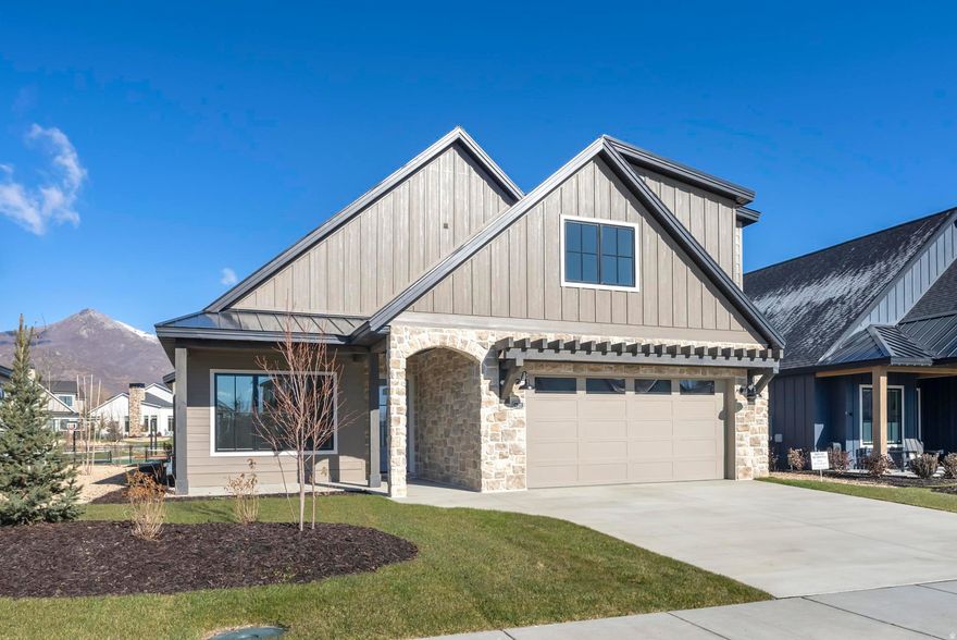 Set in the picturesque mountain town of Midway and located in the stunning community of Remund Farms, this pristine home greets you with neutral colors, custom millwork, and natural wood beams that lend beautifully to the overall aesthetic. The open floor plan provides plenty of natural light and ease of entertaining with the dining and family rooms conveniently adjacent to the daylight chef's kitchen complete with 48" range, pot filler, double ovens, quartz countertops, large eat-in island, and oversized pantry. The owner's suite features luxurious ensuite bathroom with double vanity, enclosed commode, large shower and walk-in closet that passes directly to the laundry room that includes side by side washer/dryer, full sink, upper cabinetry and convenient drying bar. An additional office, half bath, and guest bedroom with its own ensuite bath complete the main floor. Upstairs you will find an exceptional secondary family room that is perfect for relaxing or entertaining. Two spacious guest rooms, a double vanity bath, a flex space that can be used for storage, gym, additional office, or another bedroom are also featured on the upper level. Additional features include an epoxy coated garage with custom built storage cabinets and EV charging outlet. Outside you will find you are conveniently located to enjoy all that Remund Farms has to offer from the double pickleball courts, pool, clubhouse, gym, park, garden, activity barn, to the peaceful walking trails throughout. Minutes away from world renown ski resorts, golf courses, reservoirs and the tranquility of the wandering Provo River. Don't miss this opportunity to enjoy the peaceful mountain lifestyle.