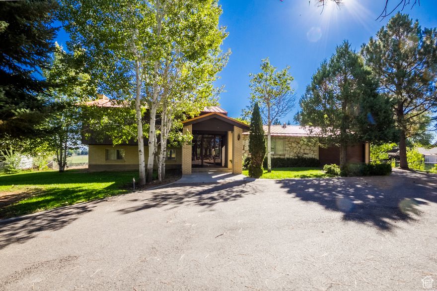 Welcome to this stunning updated home, originally built in 1966, offering a generous 4655 sq ft of living space on a sprawling .83-acre lot. This unique property boasts 4 spacious bedrooms and 3 1/2 beautifully appointed bathrooms, providing ample room for families of all sizes.  Step inside to discover two inviting living rooms, perfect for entertaining guests or enjoying cozy family evenings. The thoughtfully designed art studio allows creative pursuits to flourish, making this home an artist's paradise. The exterior is equally impressive, featuring mature trees that enhance the property's natural beauty and provide shade and tranquility. With access to irrigation water, the landscape offers endless possibilities for gardening and outdoor activities as well as wine grapes. Don't miss the opportunity to own this remarkable home that blends updated comforts with classic charm in a serene setting!