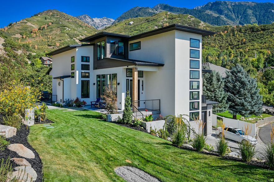 Luxury ski mountain estate at the mouth of Little Cottonwood Canyon - set on over an acre and tucked into the mountains for exceptional privacy. Surrounded by the serene seclusion of the Wasatch Front, yet perfectly positioned to capture sweeping cityscapes and stunning sunset views.   High-end, fully custom home showcasing luxury lighting, exposed steel beams, expansive windows, and oversized sliding doors, all complemented by premium finishes throughout. Extra tall custom ceilings throughout. Features a massive, uniquely designed statement wall with a fireplace and a striking concrete bench, along with a showpiece staircase and thoughtfully curated, designer-level details in every space.  Experience a rare opportunity to own a fully custom mountain estate perfectly positioned at the base of Little Cottonwood Canyon-just minutes from world-renowned Alta, Snowbird, Solitude, and Brighton ski resorts, and near the proposed canyon gondola for effortless year-round access. .   Located in a rarely available, highly coveted neighborhood east of Wasatch Boulevard, this property offers a level of privacy, setting, and proximity to the canyon that is nearly impossible to replicate. Backyard backing Bell Canyon Trailhead. Private lane, Secluded and one of a kind!  Set on a private, full 1-acre+ lot adjacent to Bell Canyon Trailhead, the home is surrounded by some of the world's most breathtaking mountain scenery.  Designed by a high-end interior designer, this residence showcases exceptional craftsmanship and uncompromising quality throughout. Expansive floor-to-ceiling windows-over 70 in total-flood the home with natural light while capturing sweeping views of the mountains, valley, and unforgettable sunsets.  The thoughtfully designed floor plan features soaring ceilings, a gourmet chef's kitchen equipped with premium Thermador appliances including a 6-burner gas range and steam oven, dual dishwashers, and three laundry sets for ultimate convenience. Incredible owner's suite with a private balcony offering unparalleled mountain and sunset views, separate huge walk-in closets, a make-up counter and a large soaker tub with an infrared sauna.   Indoor-outdoor living is elevated with a stunning deck and expansive patio spaces, gas firepit, massive built in seating perfect for entertaining or relaxing in total privacy.  A massive est 48-foot-deep garage offers exceptional storage for multiple vehicles, recreational vehicles or boat, and more.  Located just 20 minutes from Salt Lake City International Airport and a short drive to Park City, this home provides unparalleled access to world-class skiing, hiking, mountain biking, and year-round outdoor adventure-all from one of Utah's most coveted canyon locations.  A true legacy property in one of the most exclusive settings at the gateway to Utah's premier ski resorts.   Massive tandem garage with room for a boat, truck, car, and more - plus an oversized RV pad for additional parking.  Buyer to verify ALL information provided, listed on the MLS and marketing information... information is not guaranteed.   Square footage figures are provided as a courtesy estimate only and were obtained from Tax Data.  Buyer is advised to obtain an independent measurement. Owner/ Agent