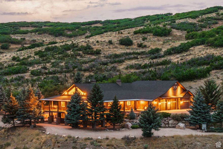 This 21+ acre property hosts a thoughtful 4 bed, 5 bathroom, 6,840 sq ft home. Main (entry)-level living with covered, wrap-around decks (approx. 2,103 sq ft) makes for easy living. An ADA bedroom and a dedicated office are also on the main floor. The spacious kitchen features cabinets with pull-out storage and a farm sink. The luxurious primary suite includes a spa-inspired bathroom, gas fireplace, walk-in closet, and direct access to the deck for serene morning views, sitting area and hot tub. Downstairs is a large theater, family room with a wet bar, reading room, two bedrooms sharing a large bathroom, walk-in safe and large storage room. The oversized (2,178 sq ft), 3-door garage can hold up to 7-cars or a combination of cars and RVs. In addition to the home's site, approximately 3.5 acres are flat and could easily provide for a barn, arena, large lawn and the like. A large fire-pit area and mature landscaping cap the offering. Minutes from Rockport Reservoir for power-boating, foiling, sailing, etc. 15 minutes to Kimball Junction, 35 minutes to downtown SLC, 40 minutes to SLC airport, 20 minutes to Woodward Park City; 20 minutes to Deer Valley Resort (tm); 25 minutes to Park City's Historic Main Street; and 45 min to Snowbasin Resort. This property "lives remote" but is in fact close to so much that the area offers. Easy to show.