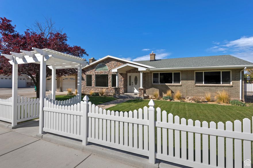 Amazing Rambler located in a desirable location! Just across the street from a park with easy access to Front Runner, shopping, restaurants, and entertainment. This home sits on a .39-acre, fully fenced lot with a covered patio, a large two-car garage, and a welcoming curb appeal. Inside, you'll find five bedrooms and three bathrooms and  nearly 3,000 square feet of open living space. The layout features large rooms, vaulted ceilings, and abundant natural light, creating an airy and inviting atmosphere throughout. Whether you're entertaining family and friends or enjoying quiet evenings at home, this residence provides versatile living areas and ample storage. A thoughtful blend of comfort and practicality, this property is perfectly suited for extended families, multi-use spaces, or a bustling household that loves to host. Don't miss the opportunity to make this exceptional rambler your new home.