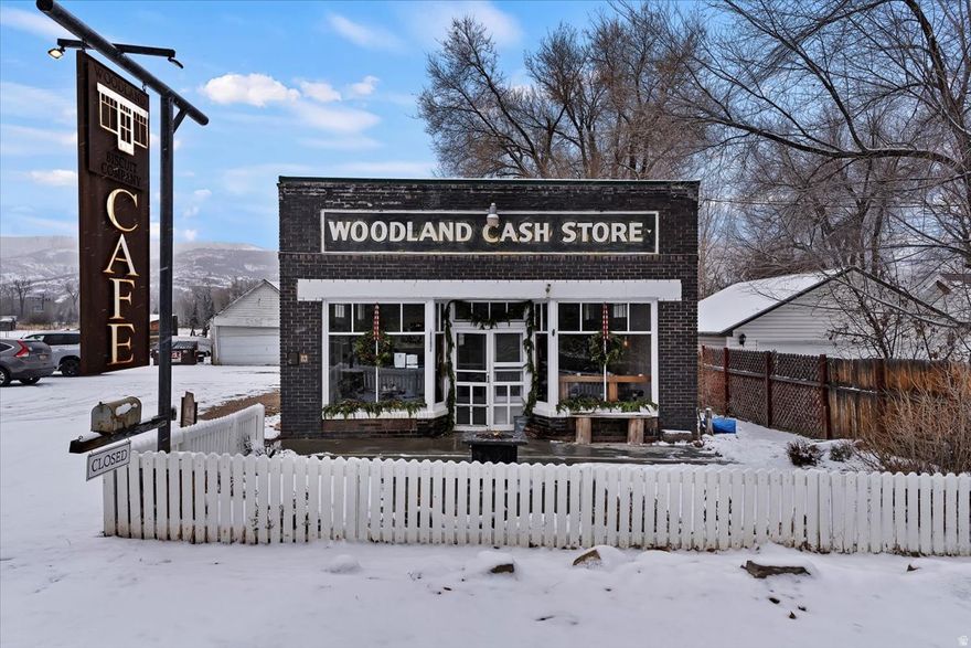 Well-maintained and full of character, this standalone commercial property offers a rare opportunity for a caf, restaurant, event venue, or specialty food concept. Established in 1930 and operating as a caf since 2015, the historic Woodland Cash Store enters a new chapter in 2025, continuing its legacy as a cherished community gathering place. The inviting storefront features classic brick construction, prominent signage, and excellent street presence, creating strong curb appeal and visibility.  Inside, the space opens to a warm and welcoming dining area with abundant natural light, polished concrete floors, and thoughtful finishes throughout. The flexible layout comfortably accommodates multiple seating arrangements, making it ideal for dine-in service, private events, or experiential retail use. Tasteful built-ins and dcor preserve the building's historic charm while maintaining a clean, professional aesthetic.  The commercial kitchen is fully equipped with stainless steel appliances, vent hood, gas range, prep space, and ample storage-designed for efficient workflow and ready for immediate operation.  Whether you're an owner-operator or investor, this turnkey property offers both functionality and atmosphere, providing a unique opportunity to operate within a space rooted in history while supporting modern commercial use. All property information, boundaries and documents to be verified by buyer.