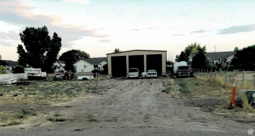 HUGE PRICE REDUCTION!!! Motivated seller,  Building lot also includes 40' x 40' insulated steel building  with 3 - 14' overhead doors,  Water, sewer and power stubbed to the lot, impact fees for water and sewer have been paid as per Elwood town, connection fees will apply,