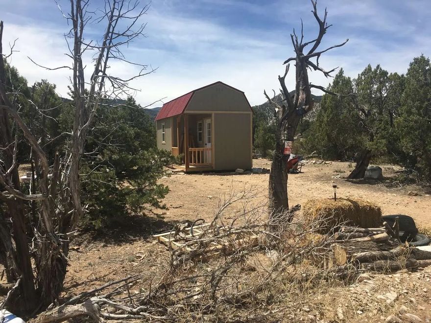 This Lot is next to the Strawberry River with a small cabin on it, 9.91 Acres of beautiful land Seller is open to seller financing. Call Agent for more information. The lot is next to the monastery, with a flat area to Build a cabin, included in purchase is existing Cabin