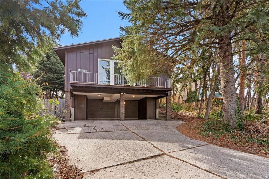 A rare opportunity to live in a mid century residence with unbeatable mountain-framed views. This well kept home offers spacious living, clean lines, an inviting and effortless connection to the outdoors, all while capitalizing on its prime mountain views.  The main level floorplan was designed to flow seamlessly between living, dining, and kitchen spaces, with expansive windows and sliding doors capturing the Wasatch scenery. The primary suite features an ensuite and generous closet space for ample storage. For modern living conveniences, updated paint and LVP flooring throughout, stainless steel appliances in the kitchen, and contemporary bathrooms on the main level. In addition, the basement offers an additional bedroom, full bathroom, and second family room. This home sits on a private .19 acre lot with low maintenance yard.