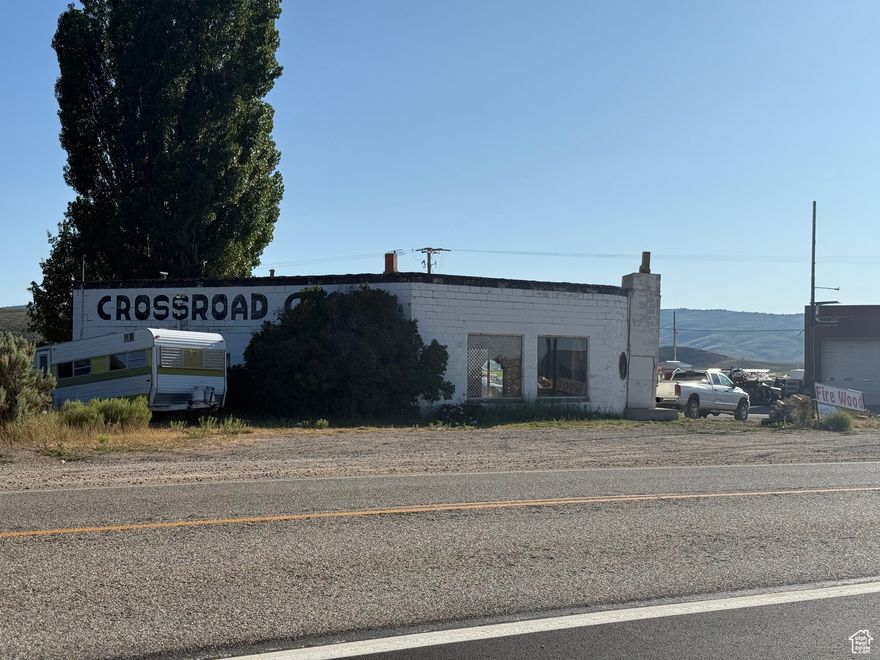 Own a piece of Laketown history! This property houses what used to be the Cross Roads Cafe. The building is still standing, but is not in great repair and is being sold AS IS. It is in a great location on the main road to the east side of Bear Lake. There is a gas station across the street and a mechanics shop next door to the gas station. This property would make for a great commercial opportunity as growth continues to move to the east side of Bear Lake. Come take a look and call with any questions.