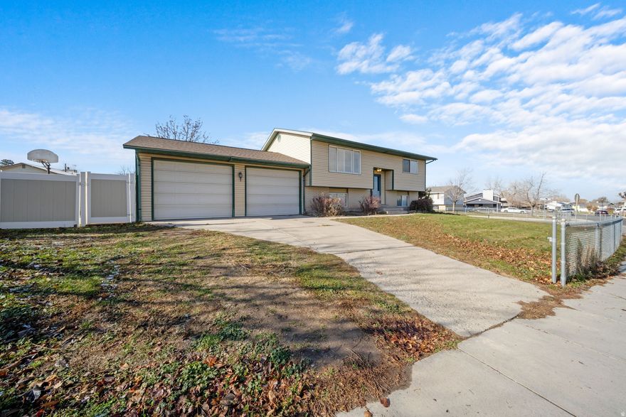 This immaculate and beautifully maintained home is sure to impress. Full of charm and thoughtfully updated, it's truly move-in ready. Enjoy peace of mind with a new roof installed in 2018, central air, and a host of quality upgrades including stunning 6" plank wood flooring, elegant crown molding, and stylish wood railing accents. The exterior is just as appealing, featuring heavy upgraded siding, a durable chain-link fence, and an extra-large deck-perfect for gatherings or relaxing evenings. The cement basketball court and fully fenced, private backyard offer exceptional outdoor living, complete with mature blackberry and raspberry bushes for summer picking. Sitting on an extra-large corner lot, this property provides space, comfort, and pride of ownership. The spacious 2-car garage with a basement entrance adds convenience and functionality. You'll want to see this one in person! Buyer is advised to obtain an independent measurement.