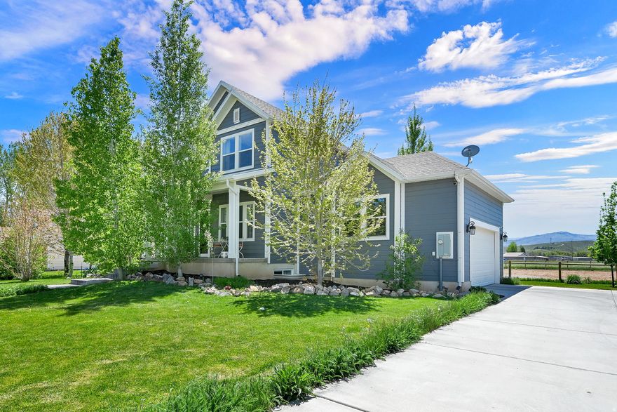 Experience elevated country living in Epic Morgan Utah, on 1.05 pristine acres framed by panoramic mountain views. Custom 4 bed 3 bath abode is truly beautiful inside and out. This exceptional equestrian estate features a professionally prepared sand-footing arena and a spacious four-stall barn, complemented by mature shade trees, curated Rocky Mountain perennial gardens, and tranquil pathways that create a private, park-like setting. Enjoy peaceful mornings on the shaded front porch and evenings beside the fire under brilliant, star-filled skies. City approved for subdivision, you have the rare opportunity to add an additional residence-significantly enhancing its investment and income potential. Ideal for equestrian pursuits, agricultural programs, boutique horse boarding, or therapeutic services, this is a refined lifestyle property with remarkable versatility and long-term value.