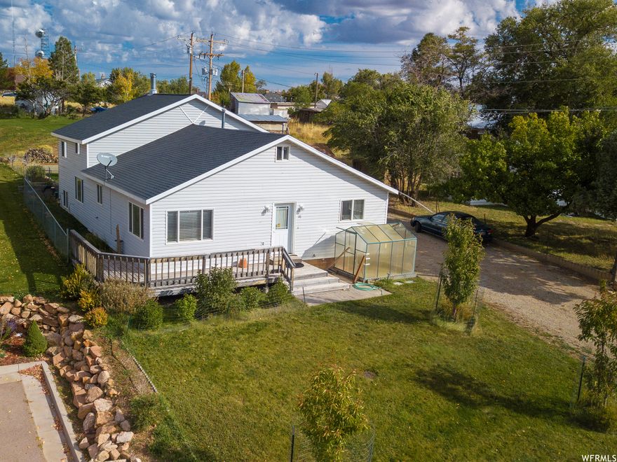 Nestled on a peaceful road just off of Main Street, this charming tri-level home offers a unique and cozy living space. Step inside to find a spacious kitchen open to the dining area, perfect for entertaining guests. The main level master bedroom features vaulted ceilings, a high built-in shelf spanning the room for plants and dcor, and a newly updated walk-in closet. The library nook upstairs also offers vaulted ceilings and a small window allowing in natural light. Outside, the south-facing deck wraps around to the west side of the home, ideal for enjoying sunsets and the fresh air. The newly built shed provides ample storage, and the spacious driveway has plenty of room for you, your guests, and even your camper! The grassy landscaped yard features lovely fenced cherry trees in the front and young pine trees in the back. To make everyday life even easier, this home is walking distance from local restaurants, shops, and an auto repair shop. The property has a residential tax designation, but could also be in commercial overlay, offering potential for mixed use.