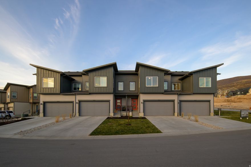 This stunning, move-in ready townhome was the former model loaded with upgrades and designer finishes throughout. You'll love the open concept layout, spacious kitchen, and large windows bringing in tons of natural light. Upstairs has a generous primary suite, plus two more bedrooms and a full bath. Includes a 2-car garage and a private patio space. Located in a prime spot in the community with easy access to trails, the lake, and all the Heber Valley has to offer.