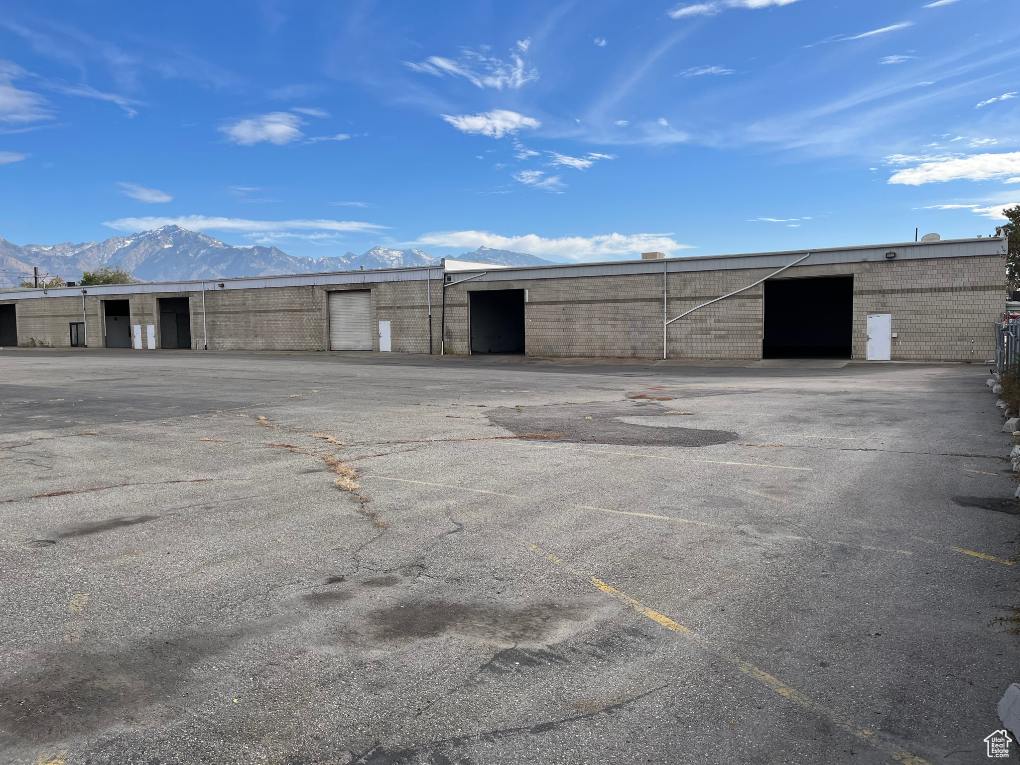 Rare industrial building with fenced and paved yard for lease.  21,500 SF with +/- 1 acre yard -  6 grade level doors, updated office space of +/- 1800 SF. Lease is NNN. Zoning is M in Millcreek city   Owner/Agent