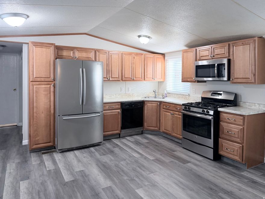 *Seller incentive. First month lot rent paid at closing* Move-in ready mobile home with a new roof in 2024, fresh interior paint, and new LVP flooring. Granite countertops in both bathrooms. Primary bedroom includes an adjoining private bath and walk-in closet. Covered deck with new carpeting. Large fenced yard with mature landscaping. Shed with electricity and workbench. Refrigerator and washer and dryer included.