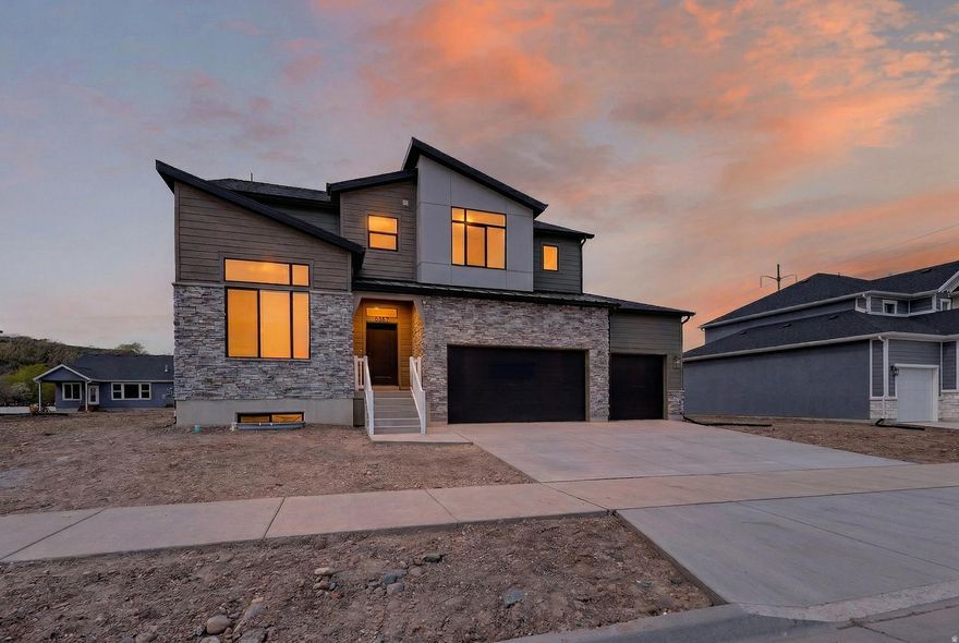 This gorgeous "Glacier" home design has it ALL!!! 3 spacious great rooms, large office, beautiful kitchen with upgraded quartz countertops, huge pantry, 6 spacious bedrooms, tiled fireplace, dual heating/cooling systems, covered patio, storage galore, 4 car garage & Plumbed for future kitchen in basement. Riverwood is South Weber's newest and most popular community. Incredible home warranty included. We are offering $12,000 + incentives - ask for details! Come see the stunning features this home and community have to offer!