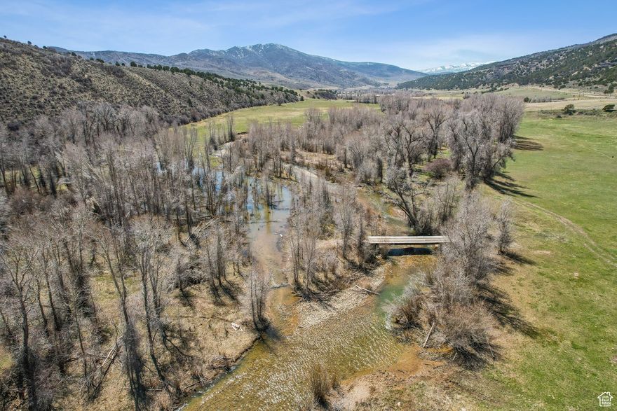 A rare legacy offering in the heart of Summit County, Chalk Creek Meadows Ranch is a true Western treasure-a 465-acre ranch that seamlessly blends working land, private recreation, a hunting paradise, and unrivaled natural beauty in one contiguous block. This is the kind of opportunity that seldom comes along-a private and adventure-rich property that speaks to the soul of the ranching lifestyle. Encompassing every coveted land type-from irrigated hay fields with senior water rights to sub-irrigated meadows, dryland farming ground, and hundreds of acres of mountain terrain-this ranch is a dream canvas for those who seek both privacy and purpose. Chalk Creek, a major tributary of the Weber River, winds through the ranch for over half a mile, offering exceptional private fishing for large brown trout and native Bonneville cutthroat. This scenic riparian corridor is framed by lush meadowlands and backdropped by rising foothills, teeming with wildlife and dramatic views from approximately 6,000 to 7,000 feet in elevation. Your private hunting and fishing grounds, with deer and elk being a regular sight in the hayfields and hillsides, and turkey hunts in the spring and fall seasons offer further adventure. The property is eligible for highly desirable hunting tags through the Chalk Creek unit, with bull elk and turkey tags available over the counter and buck mule deer tags through a high-odds draw. The setting provides sweeping views of the ranch's meadows, fields, and private water, and is supported by full utility infrastructure, including power, natural gas, septic, and culinary water from a spring, including three water rights. Located just 7 miles east of I-80 and the charming town of Coalville, the ranch is easily accessed year-round via paved Chalk Creek Road. 30 Minutes from Park City, and less than one hour from the Salt Lake City International Airport or the Heber Valley Airport. Zoned Agricultural-20, which allows for a base density of one residential unit per 20 acres, with a one-acre minimum lot size.