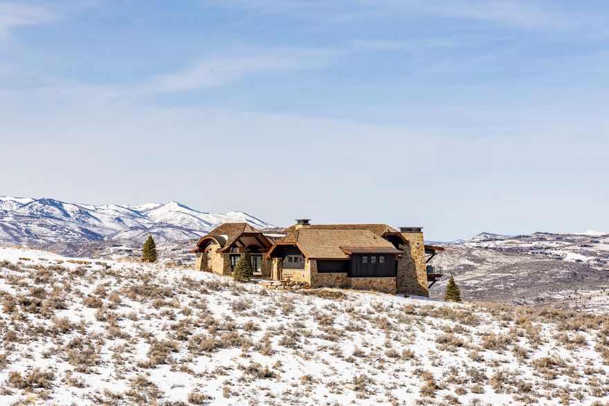 Welcome to your mountain sanctuary in the exclusive Victory Ranch community. Perched on a premier homesite, this custom-designed residence offers sweeping, unobstructed views that stretch from the iconic slopes of Deer Valley Resort to the acclaimed fairways of the Rees Jones-designed golf course, tranquil ponds,  the one-of -a-kind rock cliffs, and the peaks of the Uinta Mountains. Enjoy both sunrise and sunset from the comfort of your expansive outdoor living spaces-coveted views found only from this outstanding property. Crafted with impeccable attention to detail, the home seamlessly blends refined mountain architecture with warm, contemporary finishes. Vaulted ceilings, expansive window walls, and thoughtfully designed indoor-outdoor flow capture the surrounding landscape in every room while invoking a welcoming place to come home to. Whether entertaining under the stars or enjoying memorable times with family and friends, this home offers an extraordinary lifestyle rooted in privacy, luxury, and year-round adventure.  Victory Ranch amenities include world-class fly fishing, backcountry trails, a private ski-in/ski-out lodge in Park City, and a vibrant community unlike any other. This is more than a home-it's a legacy property for you and your family.   Victory Ranch is a private, four-season community amidst 6,250 pristine acres along four miles of the Upper Provo River. Amenities include an 18-hole Rees Jones golf course, world-class fly-fishing, miles of mountain biking and hiking trails, 5-stand shooting facility, 4x4 adventures, snowmobiles, backcountry yurts, fishing ponds, restaurants, a ski-in/ski-out lodge in Park City and more than 3,500 acres of untouched backcountry. The Barn features a pizza parlor, art studio, game room, indoor basketball court as well as a fitness center, spa, platform tennis Courts. The swimming pool, waterslide, tennis and pickleball courts and seasonal ice skating rink will be sure to provide hours of family fun. Victory Ranch is approximately 20 minutes to Park City.