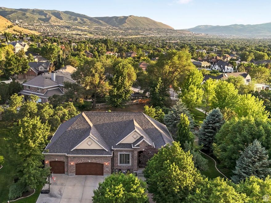 Fully updated with all new kitchen and new baths, don't miss this luxurious residence situated on an expansive 0.58-acre estate lot next to the Hidden Valley Country Club golf course with ample space for a future pool and pickleball court. This completely renovated home has had $640,000 in premium improvements since 2022 (see the attached upgrade summary). As you approach this exceptional home, the stunning exterior immediately captures your attention. From the welcoming entryway you can step into the inviting living room or elegant formal dining room-both perfectly designed for entertaining. The great room, a true centerpiece of this home, invites you to unwind and gather by the cozy gas fireplace. The all-new kitchen is nothing short of spectacular. It features custom cabinetry, gleaming quartz countertops, a pantry, and top-of-the-line appliances, including a 48-inch Wolf 6-burner range with a griddle plate, and a Thermador column-style built-in refrigerator and freezer-this kitchen is a culinary dream. The butler's pantry and beverage fridge ensure seamless entertaining, while the high-performance wood-clad range hood adds a sophisticated touch. The luxurious primary suite is a sanctuary of comfort with tall, sunny windows, vaulted ceilings, and a walk-in closet with a built-in organizer system. The all-new, spa-like primary bath is a retreat in itself, featuring a new soaking tub with traditional and exfoliating jets, a double vanity, and a separate shower with a beautifully tiled surround. The remaining three bathrooms have also been updated with new surrounds, tile flooring, vanities, countertops, and fixtures. This home is truly move-in ready with fresh paint, refinished hardwood floors, and new carpet. The finished basement, with 10-foot ceilings, offers a vast recreational room, a cozy play nook, four spacious bedrooms, and two full bathrooms-perfect for growing families or hosting guests. Additionally, you'll find a second laundry connection, a cold storage room, and two more storage rooms in the basement. Step outside to discover the professionally landscaped grounds, offering mature trees, a lush lawn, a new composite deck, a new patio, rock accents, and manicured plants. Other features include a new roof, new Renewal by Andersen windows, and new garage doors. Living in Draper, you are surrounded by world-class trail systems, breathtaking parks, and top-rated schools. The Valle di Villa subdivision also boasts a sparkling swimming pool, clubhouse, and walking path to enjoy.