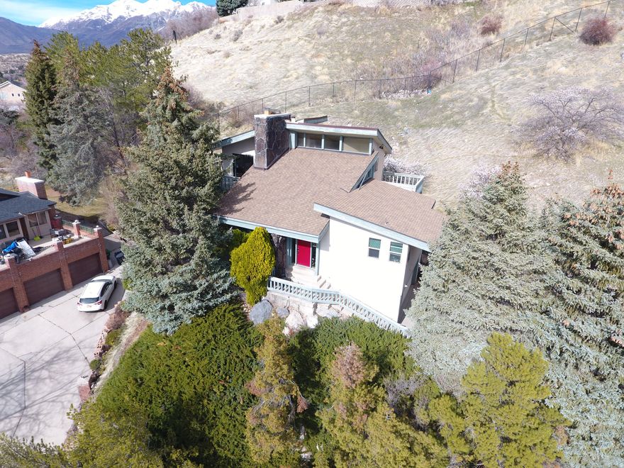 Come see this one a kind mountainside home in a private area of Sherwood Hills which sits right outside Provo Canyon. This home has some of the best views Provo has to offer of the valley and mountains. The little rock canyon trail is neighboring the property, with plenty of other trails and lookouts nearby. The home boasts 5 bedrooms with 2.75 bathrooms and a great use of the space with a unique layout that you'll love. Schedule a showing and come see this remarkable home along Provo's mountainside today!