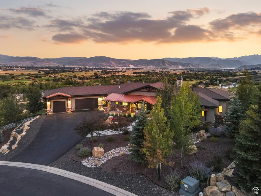 Situated above River Road in Midway, this gorgeous 6900 SF home was designed to capture the most alluring sweeping views encompassing the Provo River, Deer Creek, Mount Timpanogos to the south and Deer Valley East Village's new ski mountains to the north. Built in 2015, each room was positioned with windows framing the breathtaking vistas accompanied by the sound of the burbling water feature and quaking aspens. As the sun rises and spotlights the eastern face of Mount Timpanogos, start your day in the main level primary bedroom with a fireplace, spa bathroom and large walk-in closet. Step onto the deck shared by the adjacent office for a quick peek at emails before heading to the spacious and beautifully appointed gourmet kitchen with Thermador appliances. A discreet second office could double as a butler's pantry. The large deck overlooking Midway and beyond is perfect for year-round entertaining and planning your adventures all within your gaze. Watch the new Deer Valley lifts at East Village begin to run and access the trails within a short ten minute drive. Walk to the Provo River to fish or grab your hiking equipment for a 15 minute drive to the trails on Mount Timpanogos. With a lower level cold storage unit, an unfinished room with access to the backyard that provides additional storage or a creative renovation, and a lower level recreational vehicle garage, there are endless opportunities to be ready for year-round outdoor escapades. Family and guests will enjoy the walk-out lower level featuring a spacious family room with wet bar, three additional bedrooms, and two bathrooms. Ample parking is available in the oversized three car garage. This is more than a home, it's your private 1.09 acre mountain-view retreat with unmatched access to Utah's finest recreation and lifestyle amenities.