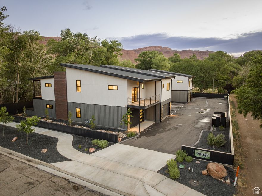 COTTONWOOD CONDOS - Welcome to an extraordinary living experience at Cottonwood Condominiums! Tucked in a quiet, tree-lined enclave centrally located in the heart of Moab, Utah, the Cottonwood Condos offers a rare opportunity to enjoy quiet in-town living with convenient access to renowned outdoor adventure destinations. Relax from your private patio under the cottonwood trees or take to the trails right from your doorstep! This beautifully designed 2-bedroom, 2-bath upper level condo, with dedicated parking space with electric vehicle charging, as well as an independent 5'x6' storage unit, offers luxury living featuring high-end finishes throughout. The open-concept layout includes a chef's kitchen outfitted with premium stainless steel appliances, quartz countertops, and custom cabinetry. This incredible opportunity to live exceptionally in Moab next to the Mill Creek Parkway provides close access to the local ball fields, library, boutiques and restaurants, with Arches and Canyonlands National Parks only a short, scenic drive away, the perfect basecamp for those who seek luxury living and expansive access to adventure!