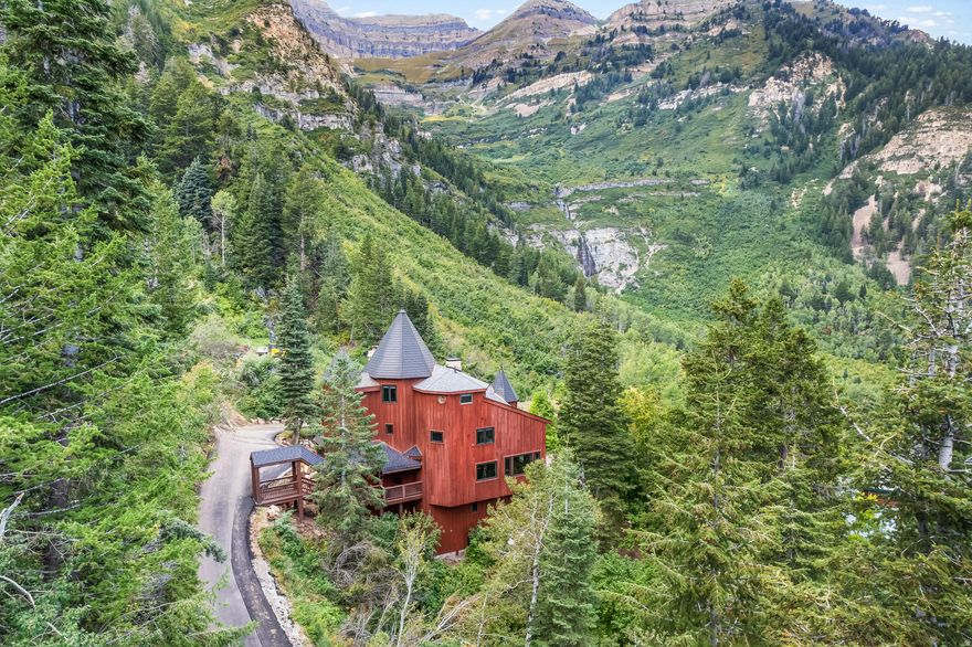 The Castle at Sundance - Tucked into 1.25 private acres with sweeping views of the surrounding canyon and toward Stewart Falls, this is one of the most unique properties in all of Sundance. Secluded, quiet, and completely surrounded by nature-yet just minutes from Sundance Mountain Resort. Recently reimagined from top to bottom, the home blends its distinctive architecture with a full-scale modern upgrade. New hardwood floors, custom finishes, and thoughtfully redesigned spaces bring warmth and function to all 5,769 square feet. The kitchen and living areas are built for gathering, anchored by multiple fireplaces and walls of windows that frame the landscape in every season. Six bedrooms offer flexibility for family, guests, or retreat-style living. Wellness and comfort were prioritized throughout, with a private gym, infrared sauna, and an 8-person hot tub set against the mountain backdrop. Nearly every major system has been upgraded-roofing, insulation, plumbing, electrical, smart controls, and more-creating a home that feels both timeless and turnkey. This is not just a cabin. It's a setting, a retreat, and a rare opportunity to own something truly different in Sundance.