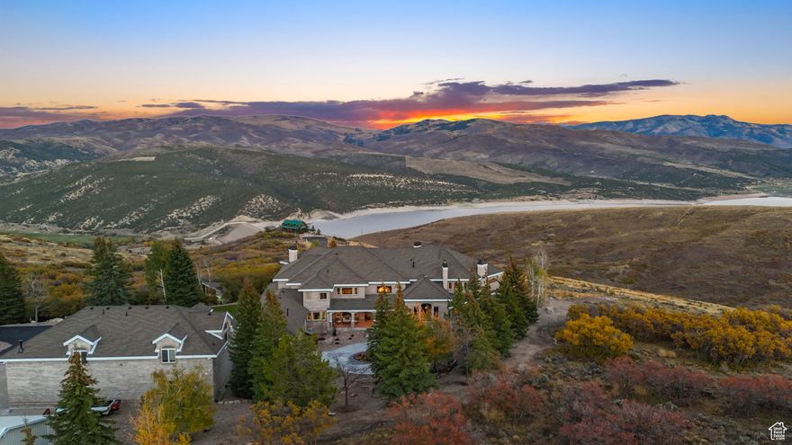 World worries? Not here because real preparedness doesn't mean hiding underground. It means thriving above it all. Arrive and relax in this gated luxury gem featuring panoramic mountain views, resort-style amenities, and a generous 2,000-sq-ft guest residence (Casita / ADU / Mother-in-Law Apartment) with its own private entrance and garage. Perfectly positioned on 21 secluded acres in Utah's Wasatch Mountain region, this updated property blends architectural craftsmanship, wellness-centered living, and elegance for the discerning buyer seeking space, privacy, and sophistication. Entering the primary residence, a two-story foyer with a grand staircase and crystal chandelier introduces timeless European grandeur. The open-concept main floor features arched two-story windows, vaulted ceilings, crown molding, and elegant fireplaces showcasing breathtaking alpine and lake vistas year-round. The primary suite offers a private sanctuary with balcony sunrise views, a coffee bar, and a spa-inspired bathroom with a deep soaking tub and body jet shower. Just steps away is an outdoor Pilates/cycling deck and a jetted swim spa, a true mountain wellness retreat. The walkout lower level is an entertainer's dream with a theater, wine cellar, music room, chef's kitchenette and bar, and an indoor basketball/pickleball court. Outdoors, reflect amid mature evergreens, a tranquil water feature, and abundant wildlife, including deer, elk, and various birds. Generous 13 garage bays accommodate RVs, boats, or car collections, offering at least 22 indoor parking spaces. And yes, there's more, a 7,200-sq-ft event center perfect for collectible sports cars, large gatherings, concerts, or equestrian activities. Though private and secluded, the estate is just 17 miles from skiing at Canyons Village and approximately an hour from Salt Lake City International Airport. This luxury estate exemplifies resort-style living surrounded by nature, the perfect blend of privacy, craftsmanship, and wellness in one extraordinary mountain retreat for those who prefer trees over traffic.