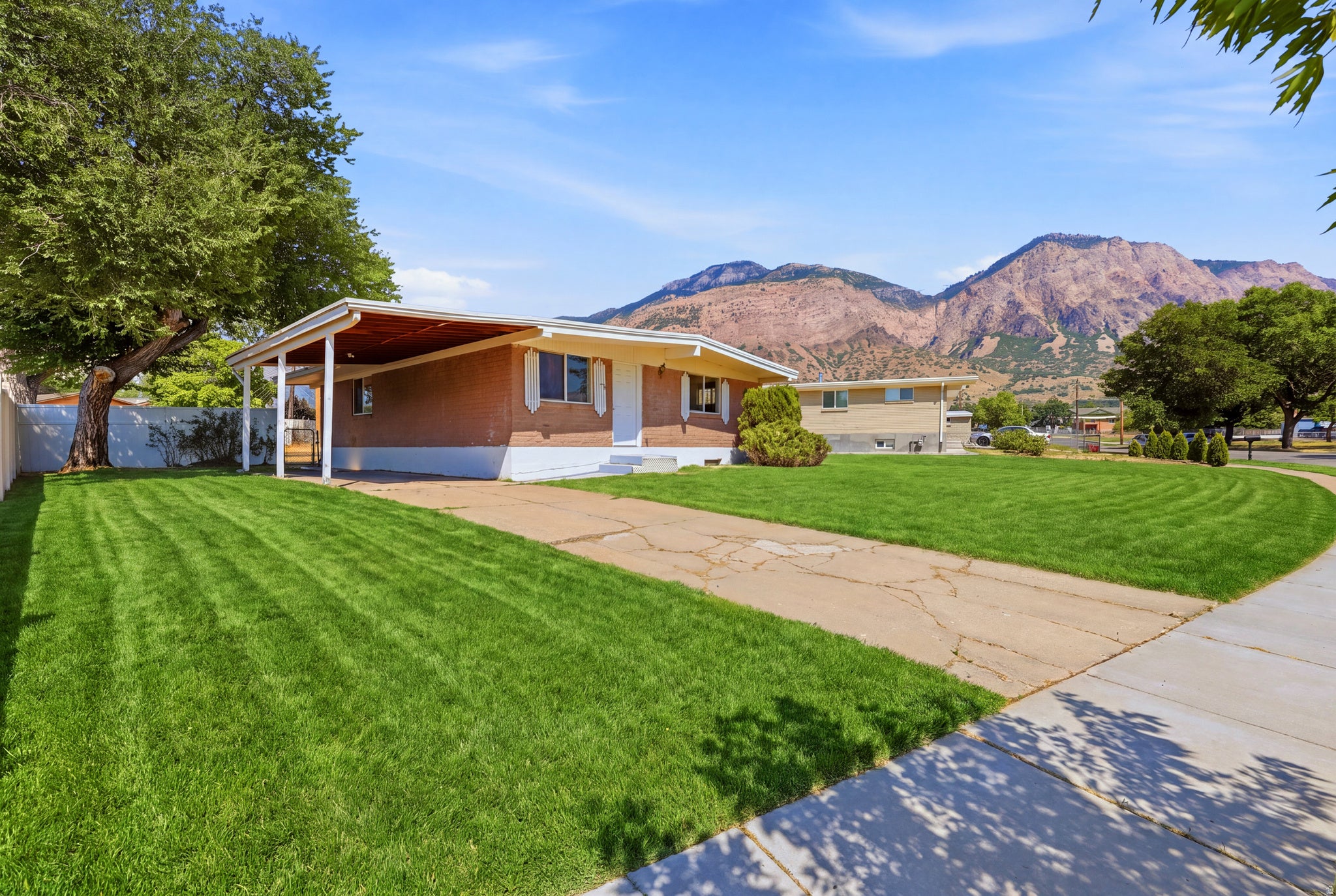 Brick exterior residence with a covered carport.   Digitally altered to enhance the appearance of the front lawn. Grass condition at time of showing may vary.