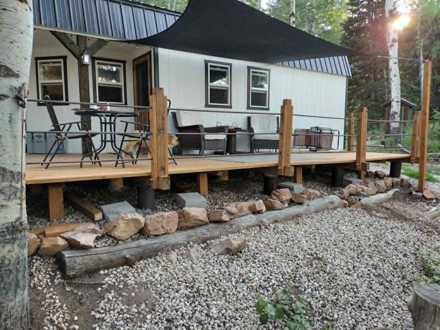 Discover the ultimate mountain retreat for hunting or family getaways in  Scare Canyon. This turnkey cabin sits on 12 private acres in the Monte Cristo recreation area. The property features a cozy main cabin with dual sleeping lofts, a separate cabana with outdoor cooking/bar area, a storage shed,  room for you to be joined by several friends and their trailers  Fully off-grid and comfortable, it includes solar panels, a generator, and two 280-gallon water storage tanks.  Enjoy mature pines, aspens, and local wildlife in this peaceful setting. Sold fully furnished-just bring your gear and start enjoying the fresh mountain air of Monte Cristo!  Cabana is 10ft by 16 ft.  Shed is 10 ft by 12 ft. Generator is Owens cummings 4000. Twin sleeping lofts that your grand kids would love that are 3ft 6 inch tall.  Home is designed for the heavy snow load found in the high elevation area.  Pond on the property attracts wildlife such as moose, bunnies, turkeys, bobcat.  Just a short  scenic drive outside of Huntsville.  There is an additional outhouse with a flushing toilet on septic.  Part of the Scare Canyon Ranch Association.