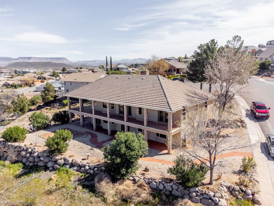 This home features 5 bedrooms, 3 bathrooms, and a 3-car garage across 3,780 sq ft. Elevated above Hurricane Valley, it offers incredible views of Pine Valley, Zion, Sky Mountain, and Cedar Mountain, framed perfectly through large kitchen windows. Enjoy a 1,000 sq ft wrap-around deck with unbeatable sunrise-to-sunset view the walk-out basement includes 2 bedrooms, a full bath, kitchenette, and a large family room-ideal for a theater, gaming, or entertaining. There's also a safe room and a backyard ready for your vision-think pool or outdoor living space. Built in 1997, the home has been updated with a remodeled master bath, new carpet, refreshed front porch, and newer windows. Additional perks include a new water heater and a garage air compressor with pneumatic lines to the deck and hobby room.