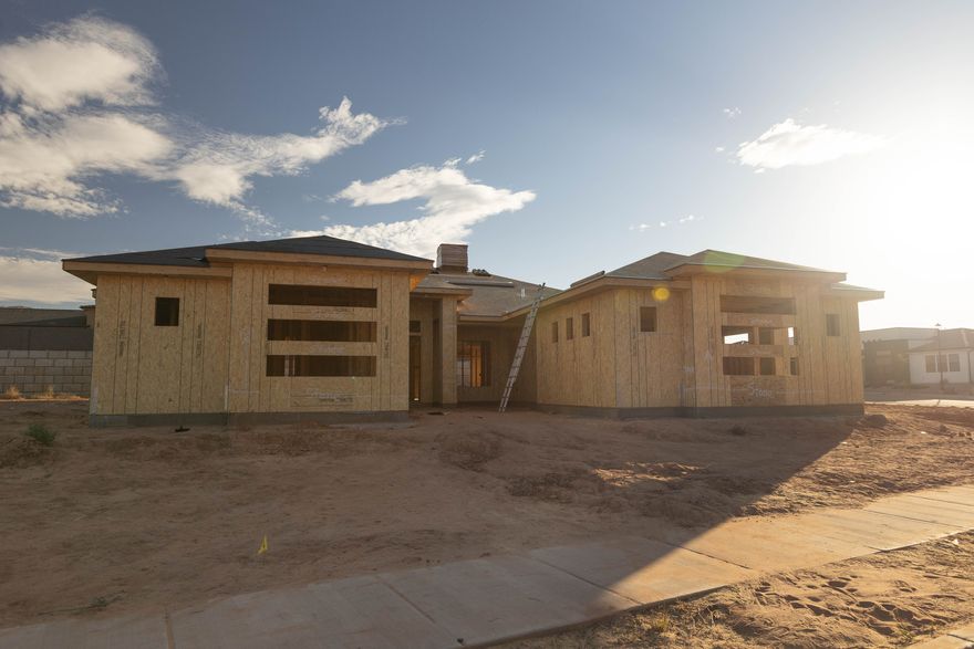 Modern desert rambler by Next Level Homes & Courtney Haslam Designs. Nearly 3,000 sq ft, 5 beds, tall ceilings, fireplaces, RV garage, pool on a private .43-acre lot. Under construction with potential finish selections. Completion spring/summer 2026.