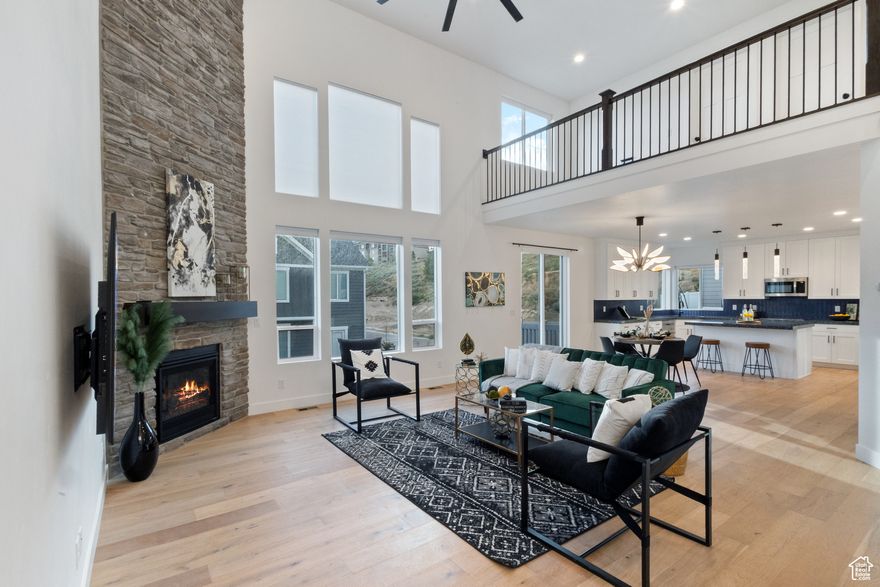 This beautiful Traverse Mountain home offers incredible views of the valley and lake, with thoughtful upgrades and a layout that checks all the boxes. Just over a year old, it feels brand new and is move-in ready.  The main level features soaring 20-foot ceilings in the living area, filling the space with natural light throughout the day. The kitchen is an entertainer's dream and you will love preparing meals with the immense counter space, upgraded features, and double ovens. You'll also find a private home office and a spacious primary suite with vaulted ceilings, a large walk-in closet, and a gorgeous, luxurious bathroom with a standalone tub and walk-in shower.  Upstairs, you'll find three generously sized bedrooms, a full bathroom, and a loft-perfect for a second living area, playroom, or home gym. The walkout basement is massive and full of potential, whether you're thinking more living space, a home theater, or a future basement apartment.  Located in a community with a clubhouse, pool, and fitness center-and close to everything Traverse Mountain has to offer-this home blends comfort, luxury, and location.  Square footage figures are provided as a courtesy estimate only and were obtained from Appraisal. Buyer is advised to obtain an independent measurement.