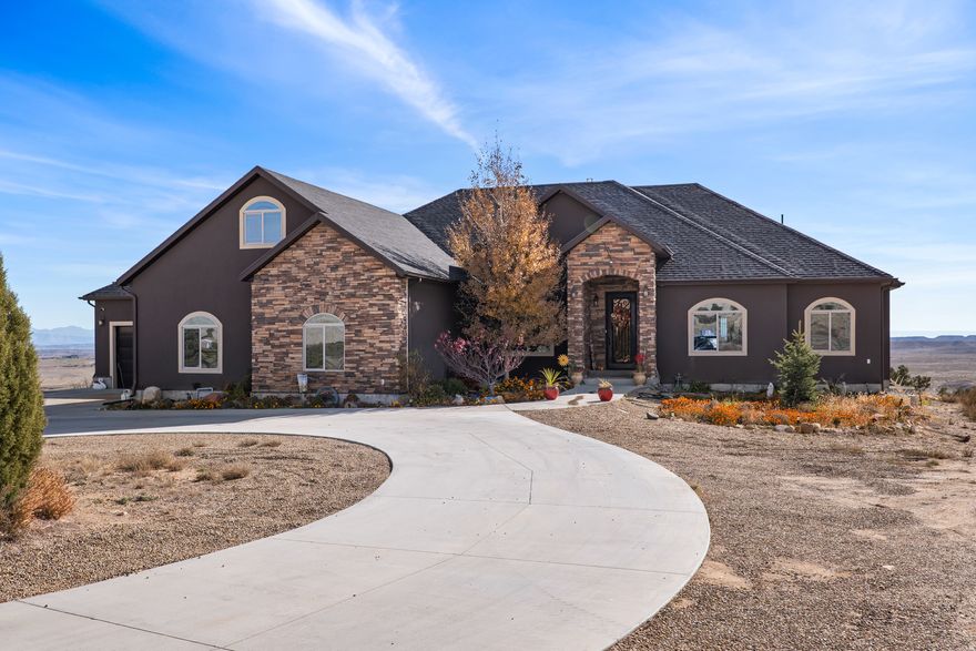 Rare Hill Top home overlooking iconic Pinnacle Peak! This stunning custom home sits on 10.66 acres in one of Carbon County's most prestigious locations. Featuring 4,493 sq ft, 6 bedrooms, 4 bathrooms, and a 4-car garage.  Enjoy an open floor plan, granite countertops, double wall ovens, pot filler, and custom tile work throughout. The fully finished walkout basement opens to a spacious patio, and a deck off the living room and master suite captures the breathtaking panoramic views. Additional highlights include a beautiful office with built-ins, a bonus room above the garage, central air with heat pump, cement circular driveway, and stunning architectural details. A truly once-in-a-lifetime property. Homes in this location rarely become available!  Square footage figures are provided as a courtesy estimate only.  Buyer is advised to obtain an independent measurement.