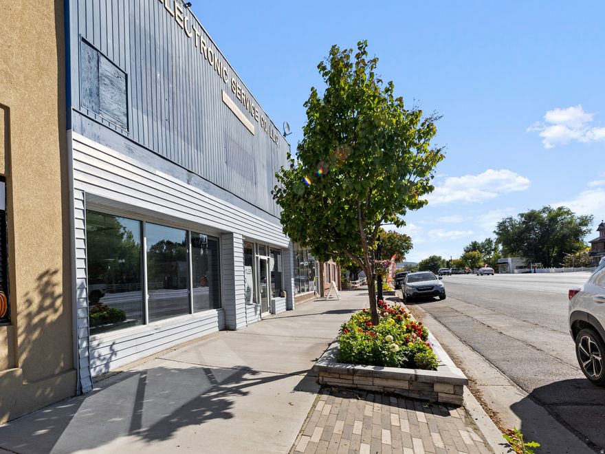 Prime mixed-use building in the heart of downtown Nephi with exceptional income potential. This versatile property offers a rare opportunity for both commercial and residential use, making it ideal for investors or those seeking a live/work environment. The main-floor commercial storefront features large, street-facing windows along Main Street, providing excellent visibility and natural light for a business presence. This space includes a private bathroom along with additional storage or office space. Adjacent to the storefront is a second commercial space with its own exterior entrance and bathroom, offering flexibility to operate as a separate unit or combine with the main storefront to create a larger commercial footprint. The property also includes two residential units. The first apartment is located on the main floor and offers a private rear entrance with a dedicated parking space. This one-bedroom unit includes washer and dryer hookups and a spacious bedroom, creating a comfortable and functional living area. The second apartment is located on the upper level and features an open-concept kitchen with a combined living and bedroom space, a separate laundry room, and attic storage. Access to the upper unit is available by stairs or stair lift, providing added convenience. Additional highlights include both Main Street and alley access, allowing easy access for tenants and customers. With the option to rent all four spaces or create a customized live/work setup, this property offers strong and flexible income potential. The seller has completed numerous updates, ensuring the building is well maintained and move-in ready. Located within Nephi's Central Commercial zoning, this is a prime opportunity to own a well-positioned multi-use property in a thriving downtown location.