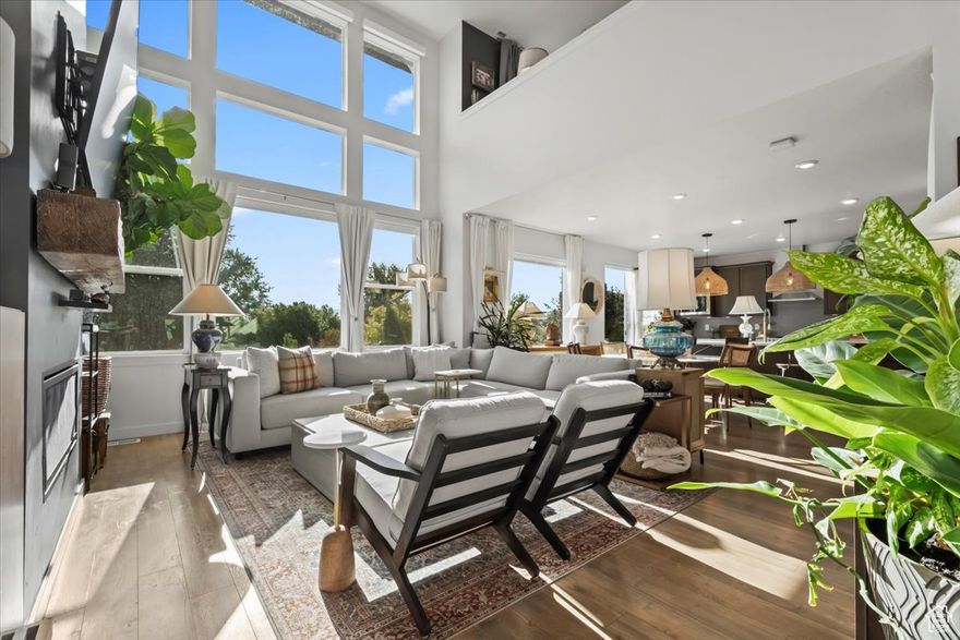 This west-facing contemporary home perfectly blends convenience and nature-inspired beauty with easy access to ski resorts, parks, restaurants, and all that South Jordan has to offer. Nestled between I-15 and Daybreak this extraordinary home features 180 mountain views, an elevated composite deck, a professionally landscaped yard, and no backyard neighbors. Inside, enjoy a main-floor primary suite, soaring two-story ceilings, a spacious loft with panoramic Wasatch views, and a completely finished basement ideal for entertaining. Designer paint and custom wallpaper add the perfect modern touch. Step outside to mature trees, the South Jordan canal trail, and abundant wildlife - from ducks and quail to deer. The community offers a large park, playground, and sweeping holiday firework views. The oversized 2-car garage includes a 50-amp Tesla Gen 3 charger and ample storage