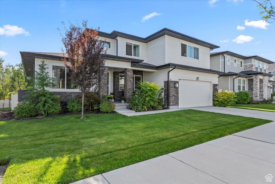 Prairie-style home with panoramic Wasatch views, natural light, oversized trex deck, finished basement, and 50 amp Tesla wall connector. Main-floor primary, vaulted ceilings, and designer finishes. Professionally landscaped yard with no backyard neighbors-enjoy South Jordan living at its finest!