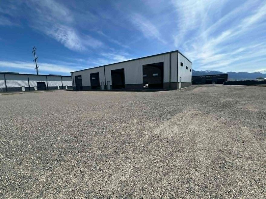 Discover exceptional opportunity in Elwood Crossing with this brand-new, duplex-style industrial building. Ideally situated in a rapidly growing area, the property boasts outstanding freeway access and high visibility at I-15/I-84 Exit 376 - perfect for businesses seeking maximum exposure and convenience. Offering a flexible footprint from 3,600 to 7,200 square feet, this space is well-suited for industrial, commercial, or retail uses. Key features include four 14-foot overhead doors for easy loading and unloading, ample on-site parking, and a secure, fenced storage yard to keep your assets safe. Commercial zoning allows for a variety of uses. The stated lease rate provides one office and one bathroom, with additional tenant improvements negotiable. The owner is open to both leasing and selling the property, making this a rare opportunity to secure a space tailored to your business goals.