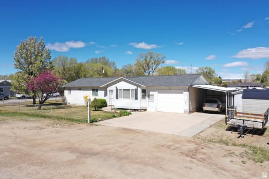 Charming single-level rambler situated on a beautifully maintained .22-acre lot in Duchesne! This 2-bedroom, 2 bath home offers comfortable living with 1,196 sq ft and a functional layout. Enjoy the fully landscaped yard featuring a variety of mature fruit trees including pear, apple, and peach perfect for those who love outdoor living and homegrown produce. The property also includes four storage sheds, providing ample space for tools, hobbies, and extra storage. With a fully fenced yard, automatic sprinklers, and a secluded feel, this property offers both privacy and convenience. Additional highlights include RV parking, covered parking, and mountain views. A great opportunity for anyone looking for a well-kept home with outdoor space and versatility!