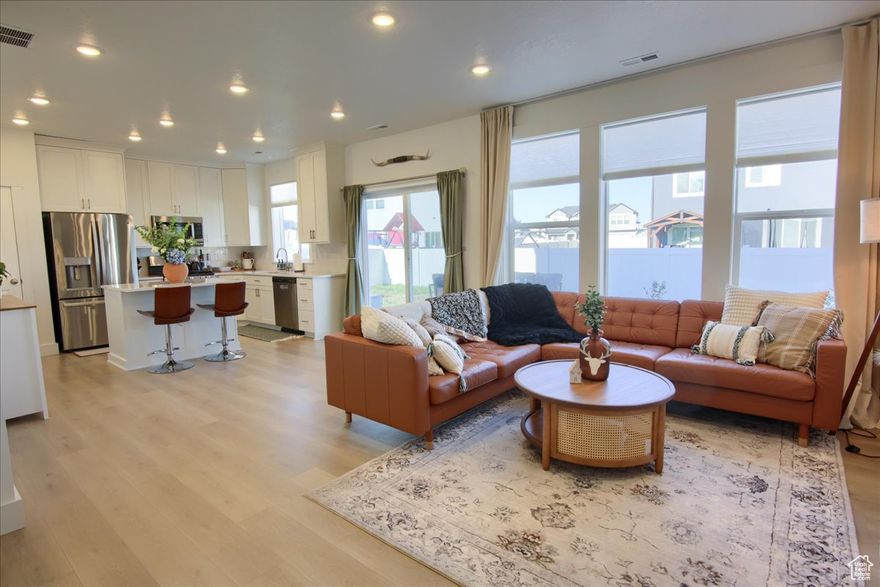 Over $15,000 in upgrades! Better than new construction, this beautiful Visionary Homes two-story in the sought-after Still Creek Subdivision offers modern comfort and style in the desirable Weber School District (Silver Ridge Elementary, Wahlquist Jr High, Fremont High). Enjoy new vinyl fencing, custom blinds throughout, blackout curtains, new stainless-steel appliances, and a one-year-old washer and dryer-all included!   The open-concept layout features a bright great room with tall windows, a stylish kitchen with quartz countertops, a center island, and a functional pantry. The cozy dining area flows perfectly for everyday living and entertaining. Upstairs, the spacious primary suite includes a walk-in closet and a private bath with dual sinks and an oversized walk-in shower. Two additional bedrooms-each with walk-in closets and blackout shades-and a convenient laundry room complete the upper level. Outside, enjoy a fully fenced yard with patio and mountain views, a covered front porch, and a two-car garage with plenty of parking. This home is move-in ready and truly better than new!