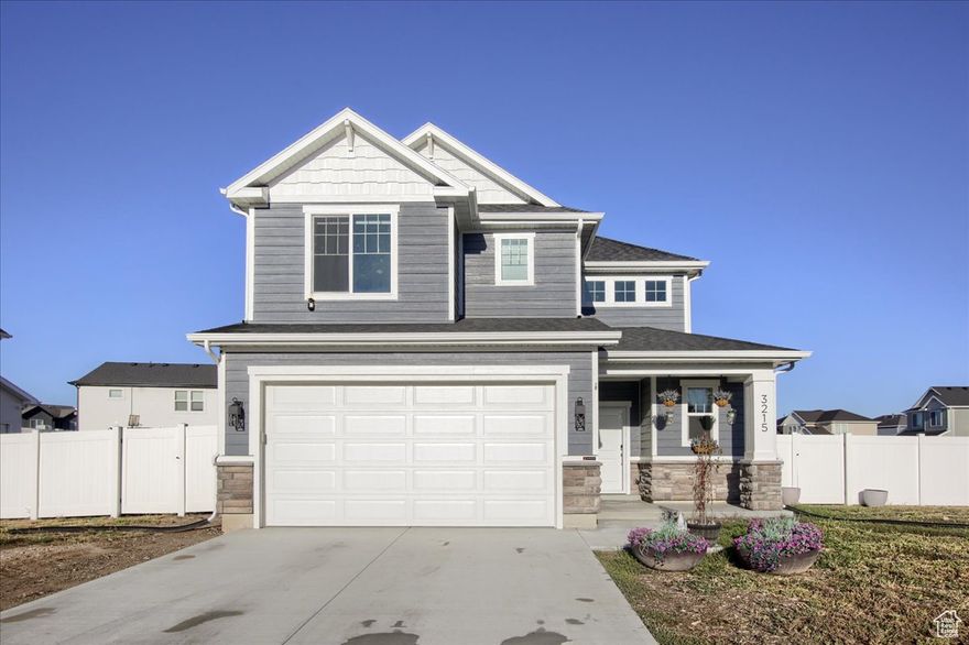 Over $15,000 in upgrades! Better than new construction, this beautiful Visionary Homes two-story in the sought-after Still Creek Subdivision offers modern comfort and style in the desirable Weber School District (Silver Ridge Elementary, Wahlquist Jr High, Fremont High). Enjoy new vinyl fencing, custom blinds throughout, blackout curtains, new stainless-steel appliances, and a one-year-old washer and dryer-all included!   The open-concept layout features a bright great room with tall windows, a stylish kitchen with quartz countertops, a center island, and a functional pantry. The cozy dining area flows perfectly for everyday living and entertaining. Upstairs, the spacious primary suite includes a walk-in closet and a private bath with dual sinks and an oversized walk-in shower. Two additional bedrooms-each with walk-in closets and blackout shades-and a convenient laundry room complete the upper level. Outside, enjoy a fully fenced yard with patio and mountain views, a covered front porch, and a two-car garage with plenty of parking. This home is move-in ready and truly better than new!