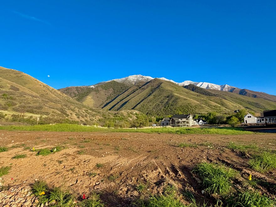 This is a must see! This lot is perched up higher than the lots to the south, east, and west - making for a surreal view of the valley and mountains wrapping this coveted East Mapleton lot. This lot was picked because it is elevated and has a quiet dead-end road wrapping around the side with amazing views.  You can't find a bad view from this lot.   The dead-end street terminates at a newly installed Mapleton city trail that connects with BLM land. The seller planned to build his dream house here, but life changed, and he needs to let it go.   It would be a fun spot to enjoy time outside all day and take in the views of the sunset over the lake, the hills full of deer, and the iconic Maple Mapleton. There would really be no reason to leave this spot.