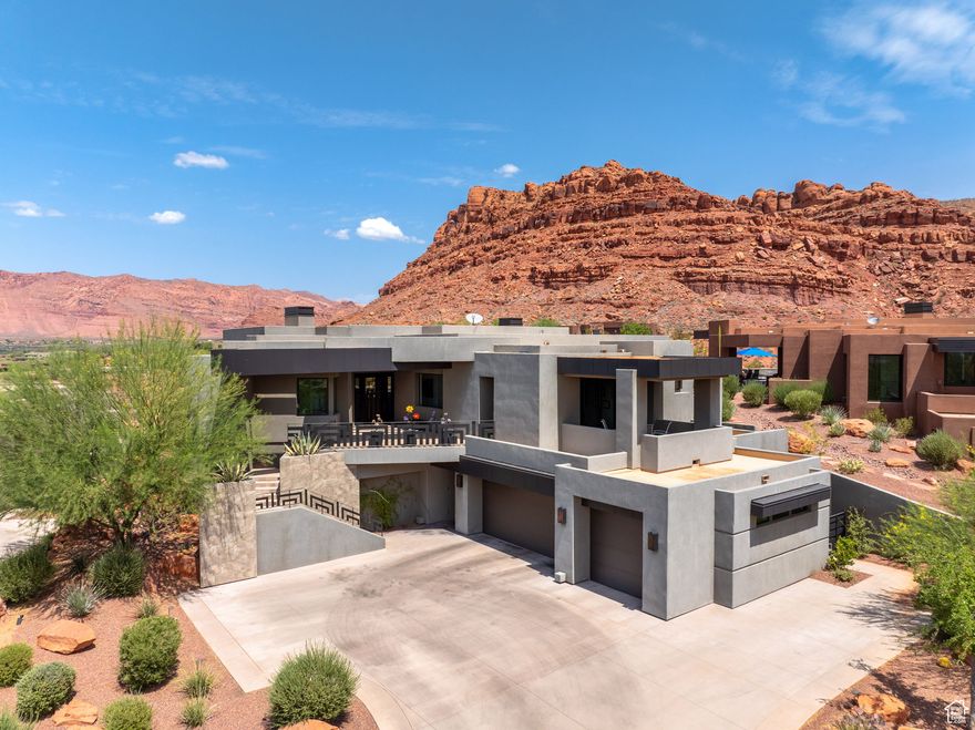 Magnificent unobstructed views of the red mountains and the entire valley-seen through expansive windows across the rear of the home. The open-concept layout is bathed in natural light, featuring formal and casual dining spaces, and seamless indoor-outdoor living. The chef's kitchen is a true masterpiece, boasting high-end quartzite and granite countertops, built-in Wolf and Bosch appliances, a heat lamp shelf, microwave drawer, oversized sink, wine chiller, and a food and butler's pantry. The spacious primary suite boasts an automatic Hunter Douglas shade, a cozy gas fireplace, and custom LED lighting. The en-suite bathroom features a garden tub, a three-head shower system (rain, handheld, and body sprays), and a boutique-style walk-in closet complete with custom cabinetry, jewelry inserts, a built-in safe, and ironing station. Guests will enjoy privacy and comfort in the attached casita, complete with a separate entrance, kitchenette, and en-suite bathroom with a walk-in shower. Features throughout include remote control shades, low voltage lighting, alarm system, central vacuum, HVAC, and Flow by Moen water monitoring. Step outside to your private resort-style backyard featuring a sparkling saltwater pool with spa, waterfall, and misters. The expansive patio includes an outdoor fireplace, built-in BBQ, and professional landscaping. Oversized 3-car garage with epoxy floors, built-in shelving, a large storage room (15x11 ft), a dog wash station, and a built-in workbench. A convenient elevator connects the garage to the main level, perfect for transporting groceries, luggage, or avoiding stairs altogether. This home includes all TVs, refrigerator, washer, and dryer. A rare combination of luxury, technology, and tranquility this is desert living at its finest.