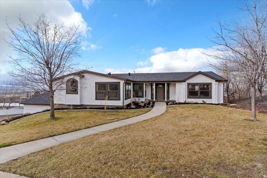 Located on the coveted East Bench of North Salt Lake, this beautifully remodeled rambler blends modern design with breathtaking views. The expansive open-concept main level showcases a stunning, fully redesigned kitchen with oversized island & all new finishes. Primary suite offers a relaxing en-suite bath with jetted tub & separate shower. A fully finished daylight basement provides three additional bedrooms & an impressive theater/great room, ideal for entertaining or relaxing. Extensive updates include new paint, flooring, fixtures & HVAC, along with abundant storage throughout. Step onto the backyard deck & enjoy sweeping views of the mountains, valley & lake. Conveniently located near golf courses, top-tier trails, downtown SLC & the airport. Schedule your private showing now!