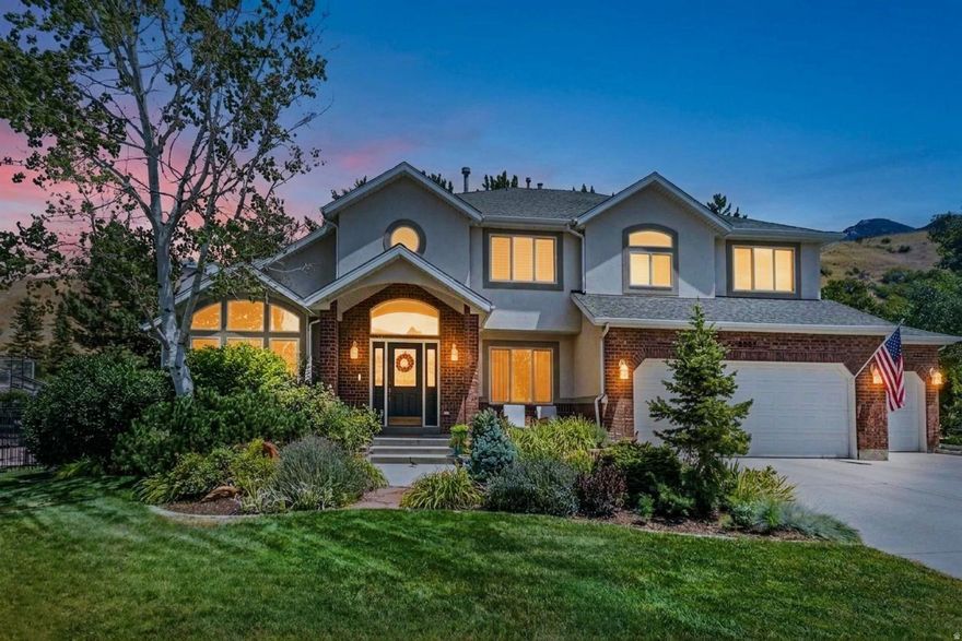 Welcome to this stunning estate in Willow Creek Estates, where luxury and functionality meet on a private 0.78-acre lot with breathtaking mountain views. This meticulously updated 7-bedroom, 5-bathroom home offers 4,496 sq ft of elegant living space, thoughtfully designed for comfort, entertaining, and multi-generational living. Inside, soaring vaulted ceilings, hardwood and marble floors, plantation shutters, and bay windows create an airy feel. The chef's kitchen boasts double ovens, built-in range, stainless appliances, and seamless flow to dining and living areas. Relax in the inviting primary suite with jetted tub, walk-in closet, and private balcony. The finished basement is ideal for extended family or guests, complete with a second kitchen, wet bar, office/den, and in-law floorplan. Outdoors, enjoy a large patio, balcony, mature landscaping, full fencing, sprinklers, and RV parking. A 3-car garage plus 4 uncovered spaces provide convenience. Modern upgrades include central air, smart thermostats, video doorbells, central vacuum, and intercom. Originally built in 1993 and fully remodeled in 2021, this home blends timeless style with today's best features. Perfectly located near parks, trails, schools, and shopping-don't miss your chance to own this Sandy showpiece! Other Notable: backyard is prewired for a hot tub, garage is prewired for an EV charger, upstairs bedroom is prewired/plumbed for laundry conversion if Upper Level laundry is desired