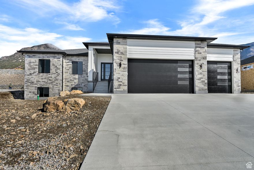 Need 6 bedrooms, and want Brand New then look no further!! The interior offers a generous kitchen with custom cabinetry, walk-in pantry, decorative wall accents, and a gas log fireplace. The master suite provides a comfortable retreat, garden tub/sep. shower, double sinks and shiplap ceiling in bedroom. Finished basement has 4 bedrooms and 2 baths, another full kitchen and it's own laundry. A walk-out basement provides ADU options and don't miss the 4-car garage with EV plug, water softener, and large covered patio 20x14 covered patio w/mountain views. NO HOA fees!