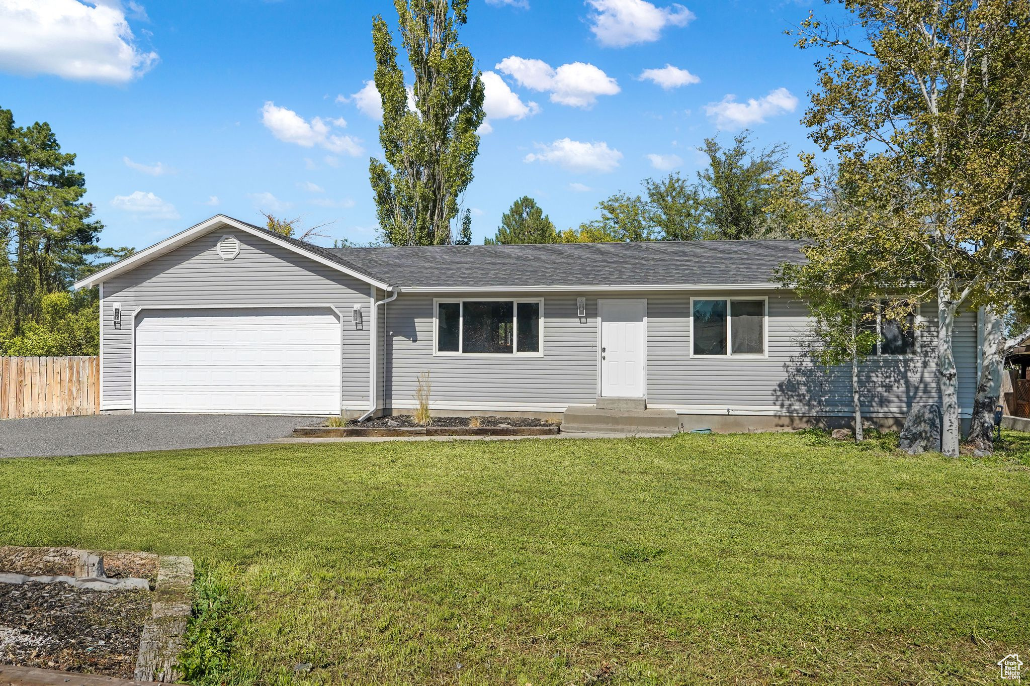 Welcome to this spacious and versatile home located in a quiet Grantsville neighborhood. Sitting on a generous .28-acre lot, this property offers room for everyone - and everything! Inside, you'll find two complete living spaces, one on each level, each with its own updated kitchen featuring crisp white cabinets, a laundry area, and a full bathroom. With five bedrooms total. Full basement Mother in law apartment. No separate entrance. The attached four-car garage and separate one-car shop out back provide endless possibilities for storage, projects, or hobbies. The large yard offers plenty of room to play, garden, or simply relax, and there's ample parking for everyone. This home has all the space, comfort, and small-town charm you've been looking for - come see it today!