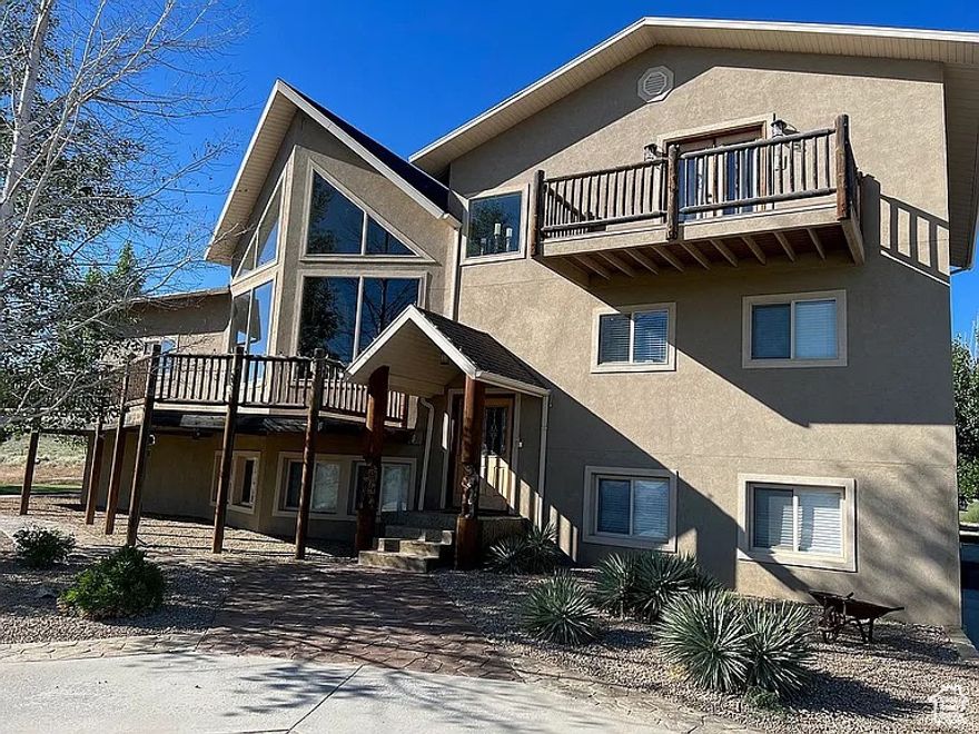 MOTIVATED SELLERS! This beautiful lodge-inspired custom-built home sits 1 mile down a dead end road for minimal traffic. This home has so much to offer and more. The home sits at the back half of the property and has a long stamped concrete circular driveway with a beautiful water feature in the middle. BRAND NEW CARPET & padding throughout. 5 extra large bedrooms with walk in closets, 2 3/4 baths, with separate jetted tub and shower in the master suite, including a private balcony, his and her sinks and walk in closets. Large vaulted living area with 20' ceilings and large windows top to bottom for plenty of natural lighting. Hand-scraped hardwood hickory floors, 2 gas fireplaces, and more. Full walk-out basement with huge family/rec room. Large loft with railing that overlooks the living area below. Over 1100 sq feet wrap around deck with approx 240 sq feet covered with a natural gas built in bbq, sink and concrete counter top. 3 sided deck to enjoy views from all angles. Detached 20X40 shop (10' garage door) and 12X40 covered carport with a concrete driveway and gate for its own entrance. 12X26 Shed with double doors and 8X26 covered area with enclosed dog kennel. Tons of additional RV parking or for other vehicles on gravel. Square footage based off county records and builder plans. Estimates only. Buyer and buyers agent to verify all info.