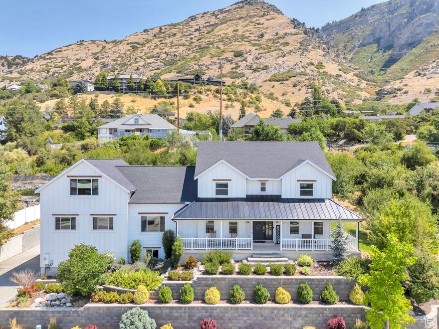 Nestled above BYU, this stunning mountainside home offers beautiful views of the valley and Utah Lake. Inside, the home exudes sophistication with elegant hardwood floors that flow seamlessly into a formal dining area. The chef-inspired kitchen boasts pristine granite countertops, a deluxe gas range, and double ovens, making it a dream for both cooking and entertaining. A main-level bedroom with an on-suite bathroom adds great options. Upstairs, the primary suite serves as a private sanctuary, featuring a spacious walk-in closet, double vanities, a soaking tub, and a luxurious enclosed shower designed for ultimate relaxation. The expansive basement is perfect for entertaining and offers potential as a mother-in-law suite, complete with its own large workshop, equipped with both power and water. This home has been meticulously updated with a 2019 roof, new hardy board siding, and energy-efficient windows. The private .61 acre lot has wonderful mature trees. Perfectly located just minutes from BYU, Provo Canyon, hiking trails and Timpview High, this property combines tranquility with convenience.